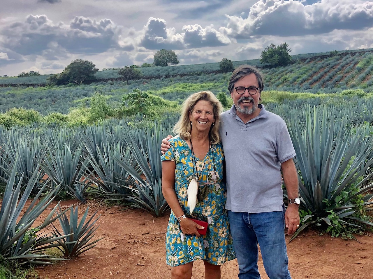 Lisa and Stuart Woolf stand in front of their test plot of agave plants in central California.